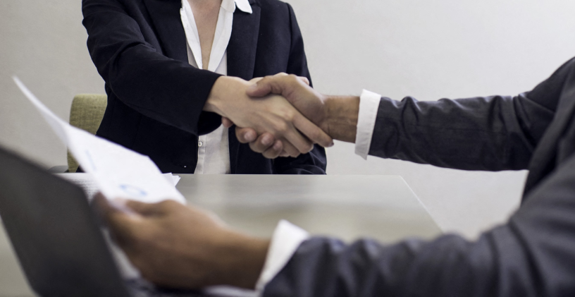 Professionals shaking hands in business meeting (Photo by Gabriel Sanchez / AltoPress / PhotoAlto via AFP)