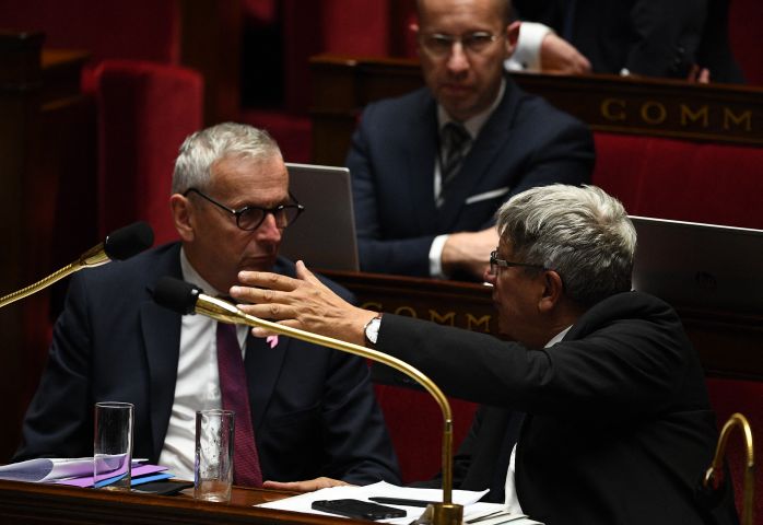 Jean-René Cazeneuve et Eric Coquerel (Photo by Christophe ARCHAMBAULT / AFP)