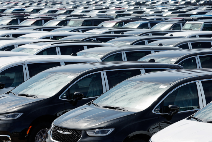 Chrysler Minivans that were assembled at the Stellantis Windsor Assembly Plant sit in a storage lot nearby in Windsor, Ontario, on April 3, 2025. (Photo by JEFF KOWALSKY / AFP)
